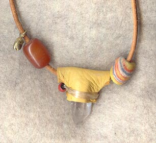 Tan buckskin wrap over Arkansas quartz crystal; one of those tropical palm kind of seed beads